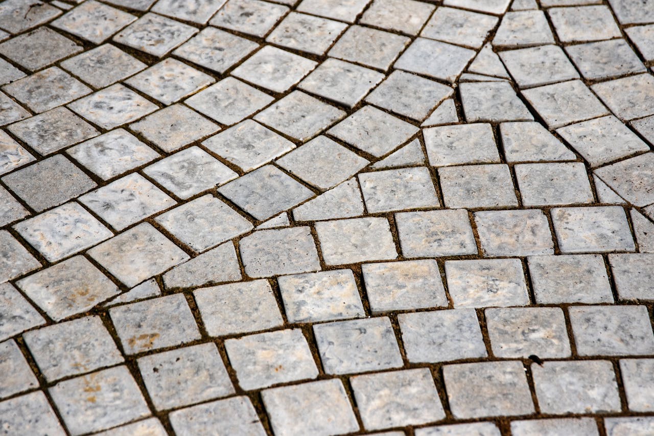 Close-up of an intricate stone pavement showcasing detailed texture and grey tones.